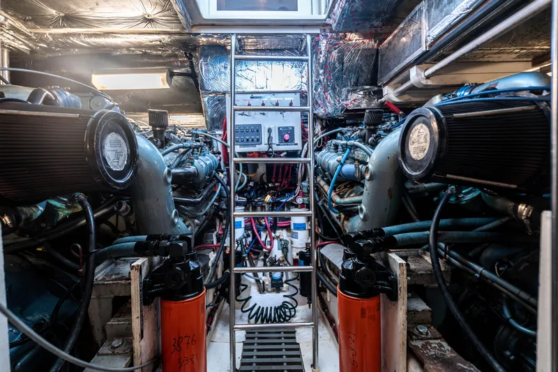 Slide: The Image of Engine room of a 1995 Tiara Yachts 4300 Open, showcasing dual engines and control panel. - 37
