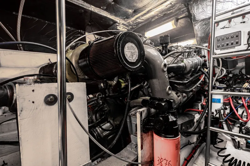 Slide: The Image of Engine room of a 1995 Tiara Yachts 4300 Open, showcasing mechanical components and wiring. - 38