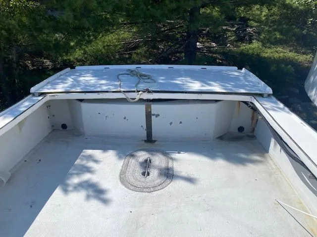 Slide: The Image of 1996 Crowley-Beal 28 boat deck with rope, surrounded by trees. - 3