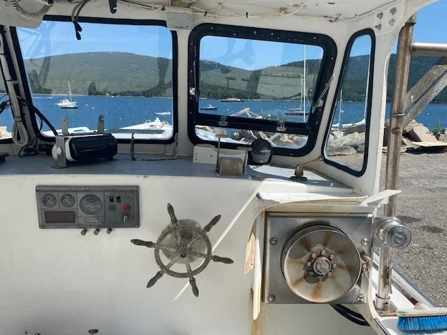 Slide: The Image of Interior of a 1996 Crowley-Beal 28 boat with steering wheel and ocean view. - 5