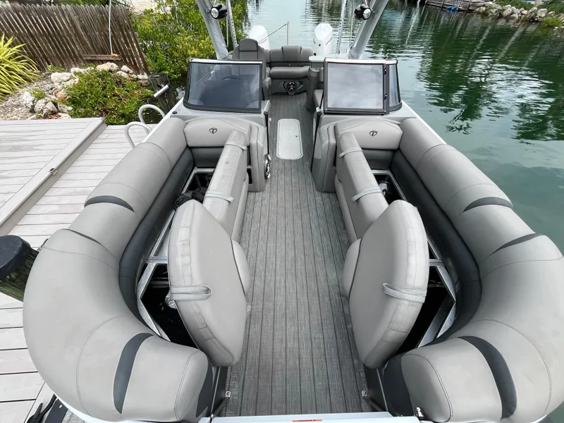 Slide: The Image of 2021 Tahoe Grand Tahoe ELW boat interior with gray seating and dual consoles. - 26
