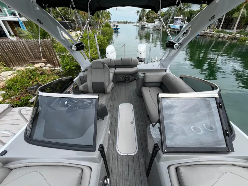 Slide: The Image of 2021 Tahoe Grand Tahoe ELW boat interior on a scenic waterway. - 28