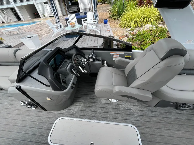 Slide: The Image of 2021 Tahoe Grand Tahoe ELW boat interior with sleek gray seating and modern dashboard. - 31