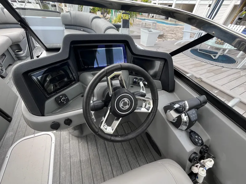 Slide: The Image of 2021 Tahoe Grand Tahoe ELW boat dashboard with steering wheel and controls. - 32