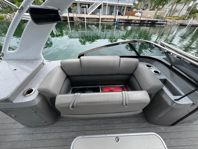 Slide: The Image of 2021 Tahoe Grand Tahoe ELW boat interior with gray seating and storage compartment. - 33