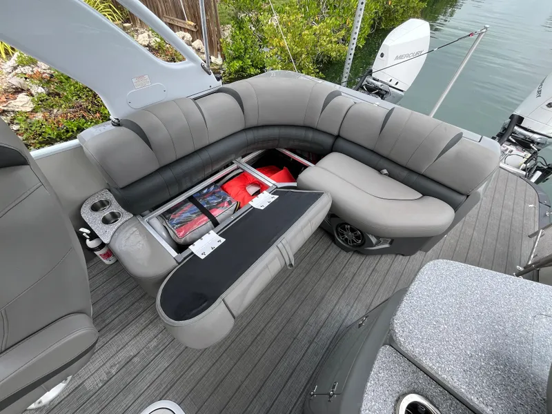 Slide: The Image of 2021 Tahoe Grand Tahoe ELW boat with gray seating and storage compartments. - 36