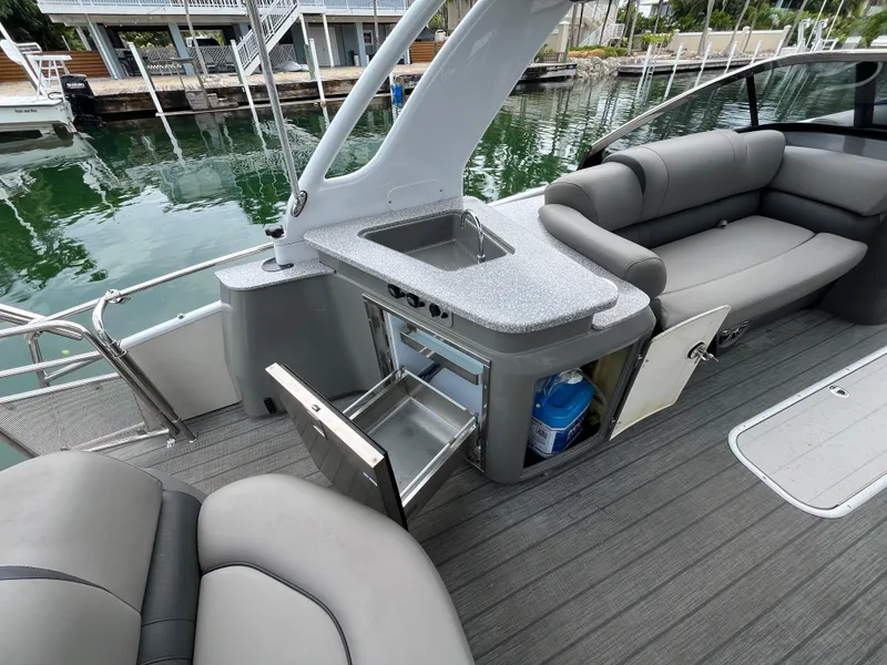 Slide: The Image of 2021 Tahoe Grand Tahoe ELW boat interior with seating, sink, and storage compartments. - 39