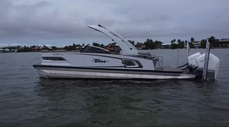 Slide: The Image of 2021 Tahoe Grand Tahoe ELW boat on calm water under cloudy sky. - 41