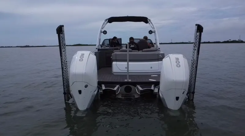 Slide: The Image of 2021 Tahoe Grand Tahoe ELW boat on water, rear view with dual engines. - 42