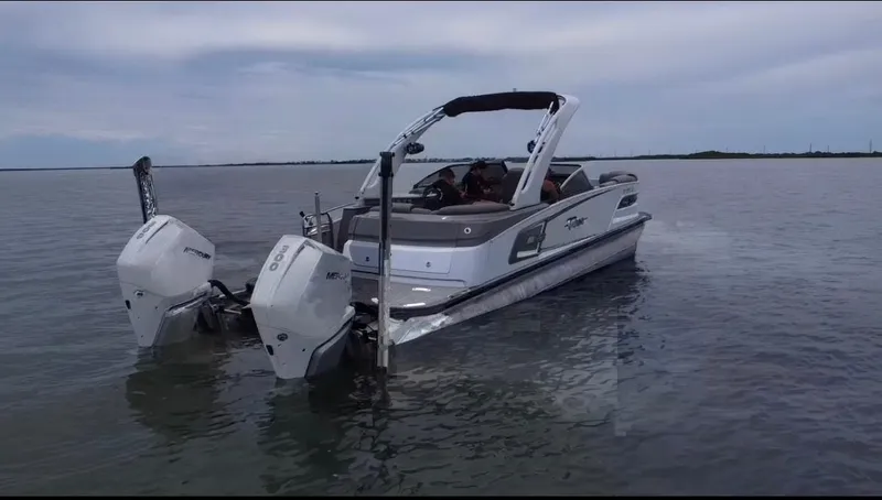 Slide: The Image of 2021 Tahoe Grand Tahoe ELW boat with dual engines on calm water. - 43