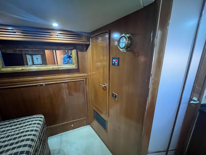 Slide: The Image of Interior of 2001 Carver 530 Voyager yacht with wood paneling and nautical decor. - 11