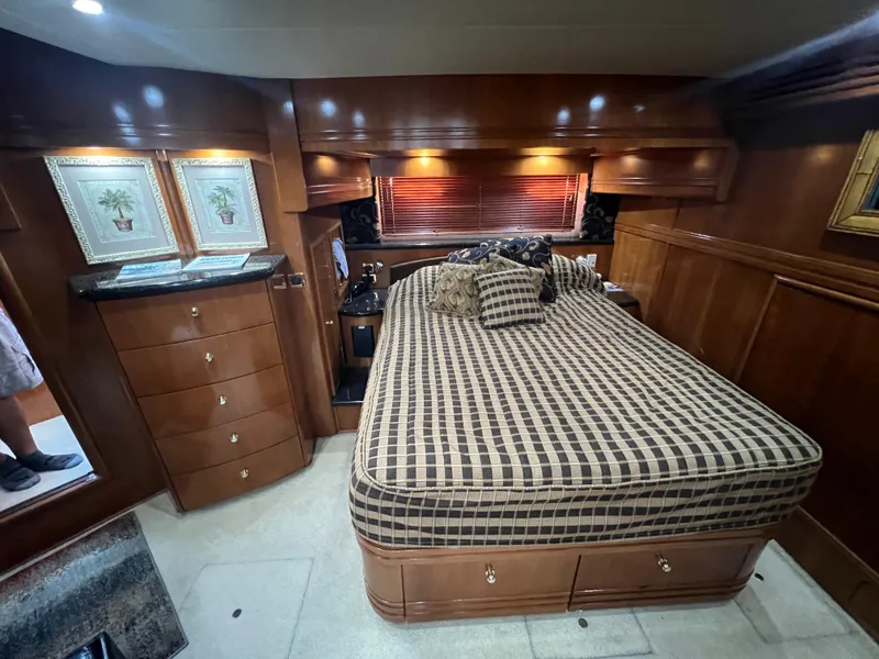 Slide: The Image of Luxurious 2001 Carver 530 VOYAGER bedroom with wood cabinetry and checkered bedding. - 12