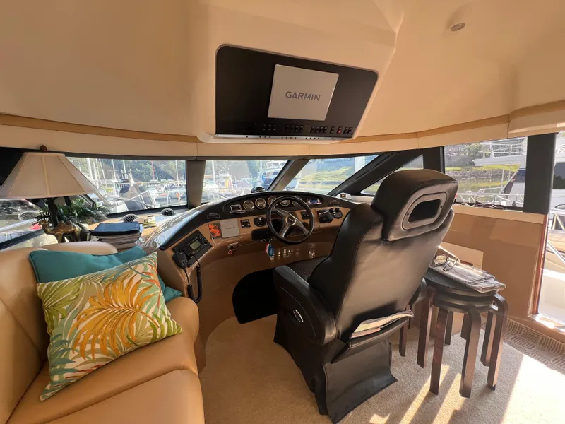 Slide: The Image of Interior of 2001 Carver 530 Voyager yacht with helm, seating, and Garmin navigation system. - 18