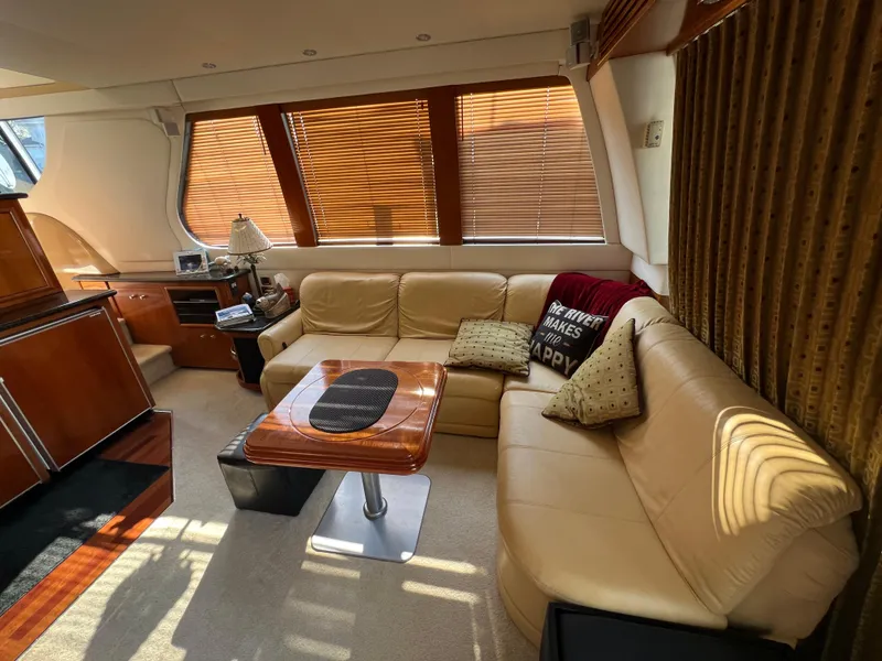 Slide: The Image of Luxurious interior of 2001 Carver 530 Voyager yacht with leather seating and wooden accents. - 20