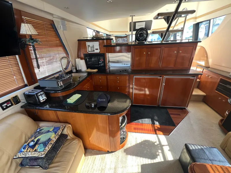 Slide: The Image of Luxurious 2001 Carver 530 VOYAGER yacht interior with modern kitchen and cozy seating area. - 22