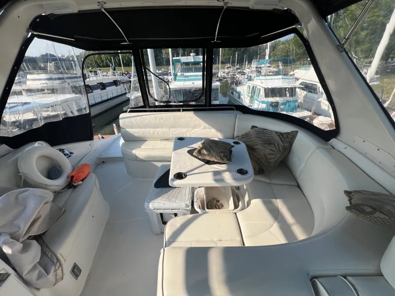 Slide: The Image of Interior of 2001 Carver 530 VOYAGER yacht with white seating and table. - 25
