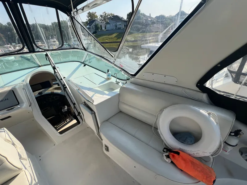 Slide: The Image of Interior of 2001 Carver 530 VOYAGER yacht with white seating and helm. - 26