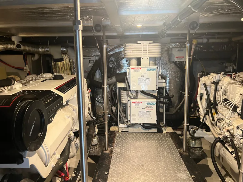 Slide: The Image of Engine room of 2001 Carver 530 Voyager yacht, featuring mechanical equipment and piping. - 29