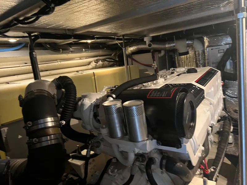 Slide: The Image of Engine room of 2001 Carver 530 VOYAGER yacht, showcasing mechanical components and piping. - 30