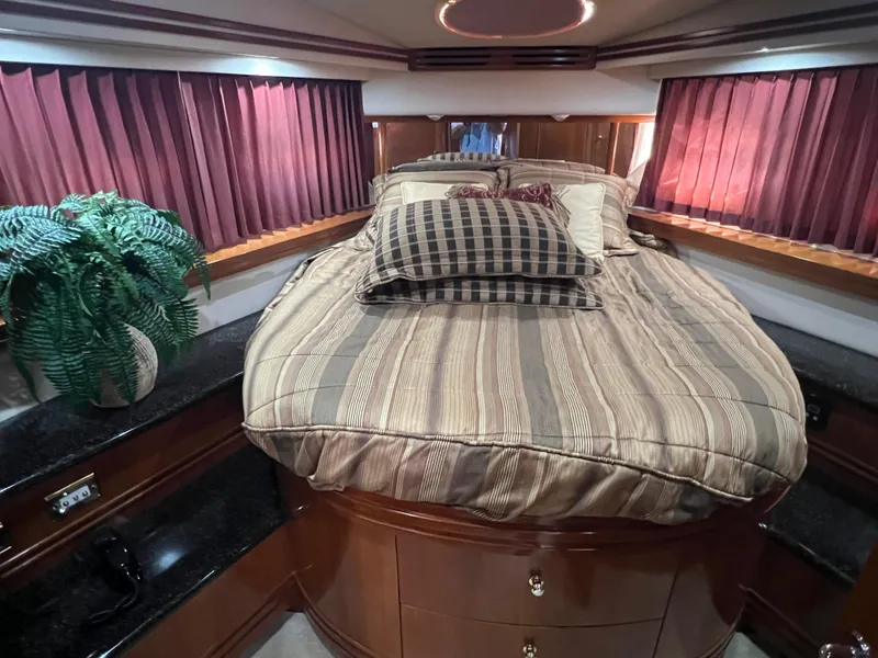 Slide: The Image of Luxurious bedroom interior of 2001 Carver 530 VOYAGER yacht with elegant bedding and decor. - 4