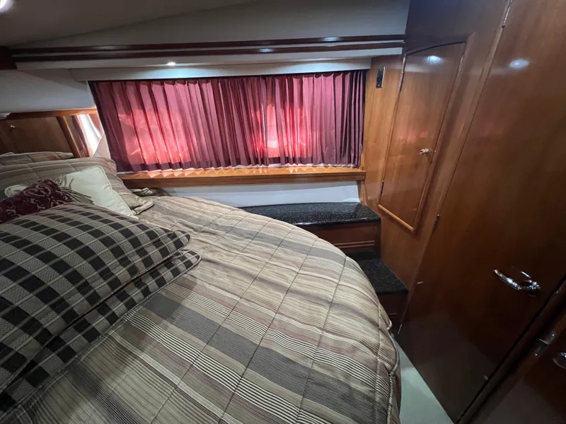 Slide: The Image of Luxurious bedroom interior of 2001 Carver 530 Voyager yacht with plaid bedding. - 5