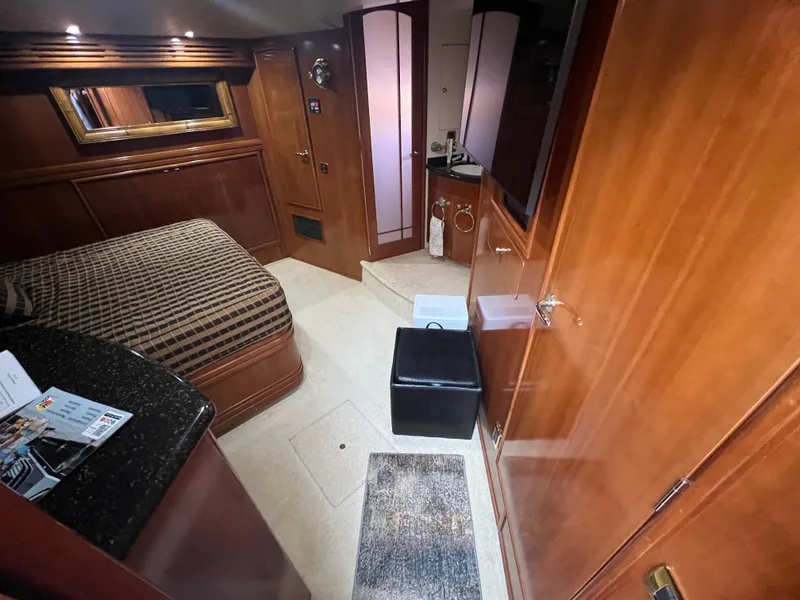 Slide: The Image of Luxurious interior of 2001 Carver 530 Voyager yacht with wood finishes and cozy bedroom. - 8