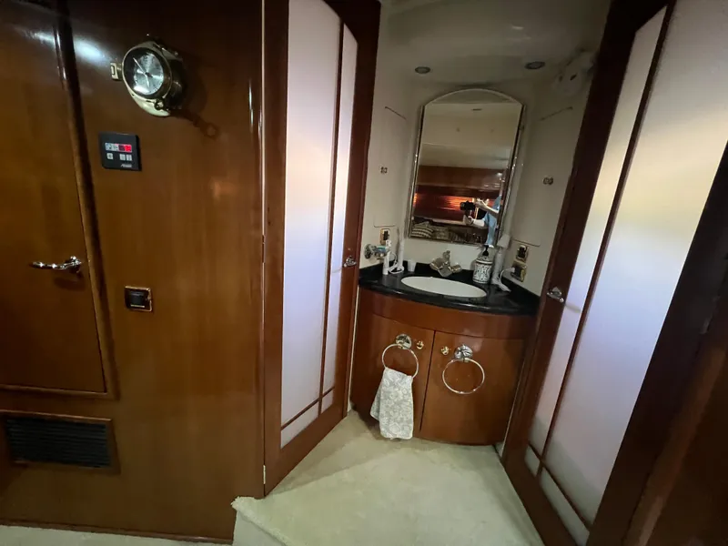 Slide: The Image of Luxurious 2001 Carver 530 VOYAGER yacht bathroom with wood accents and modern fixtures. - 9