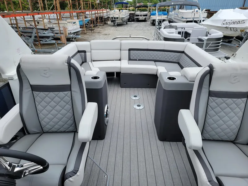 Slide: The Image of Luxurious 2025 Godfrey AquaPatio 255 ULC pontoon boat interior with plush seating. - 10