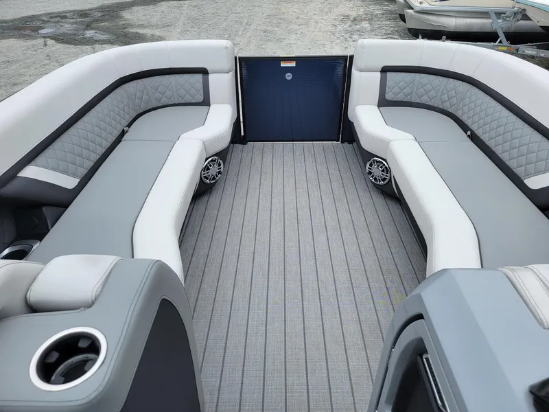 Slide: The Image of 2025 Godfrey AquaPatio 255 ULC boat interior with gray and white seating. - 21