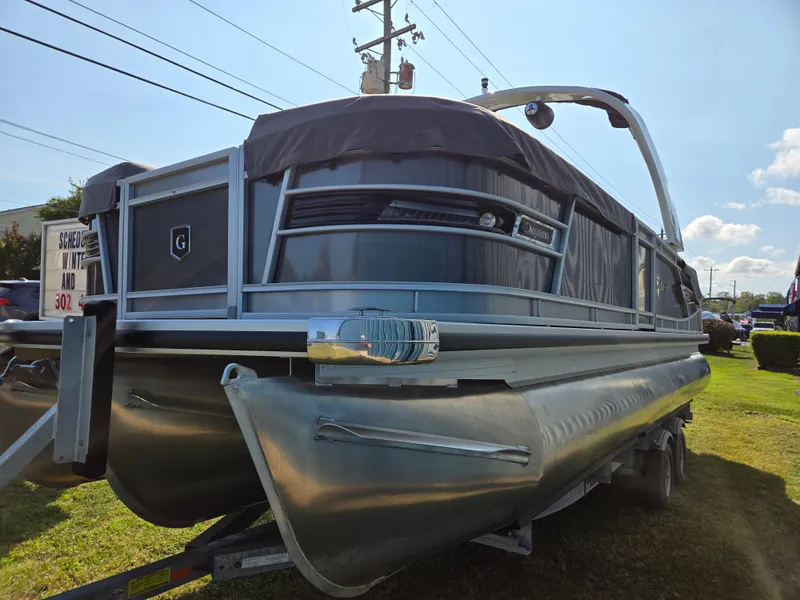 Slide: The Image of 2025 Godfrey AquaPatio 255 ULC pontoon boat on display outdoors. - 6