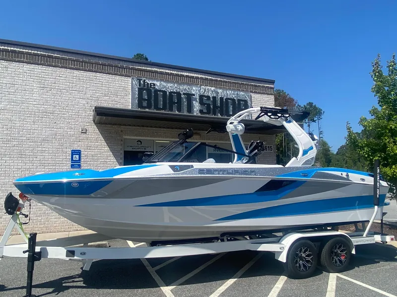 The Image of 2025 Centurion Fe23 boat in blue and white, parked outside The Boat Shop. - 0