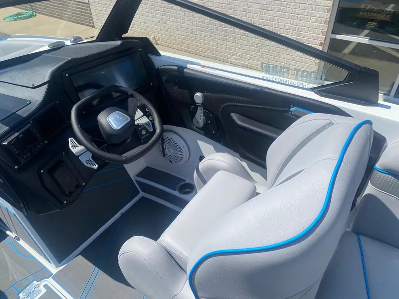 Slide: The Image of Interior of 2025 Centurion Fe23 boat with modern steering and seating. - 14