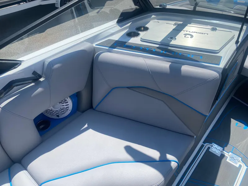 Slide: The Image of 2025 Centurion Fe23 boat interior with gray seating and blue accents. - 15