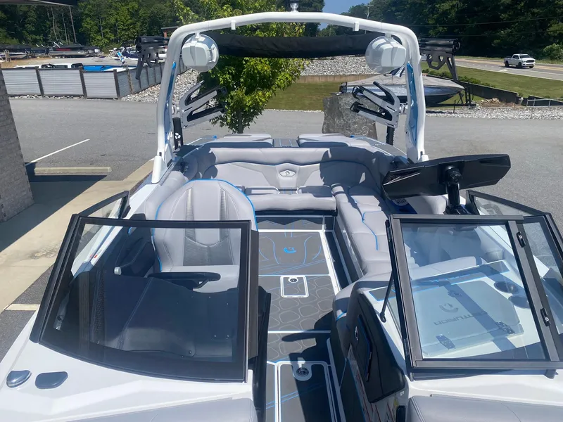 Slide: The Image of 2025 Centurion Fe23 boat interior with sleek seating and modern dashboard design. - 17