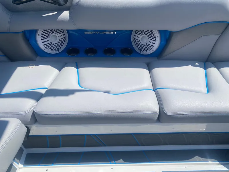 Slide: The Image of Centurion Fe23 2025 boat interior with gray seating and built-in speakers. - 19