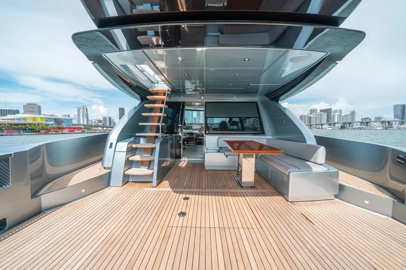 Slide: The Image of Luxurious 2017 Riva 76' Perseo yacht deck with modern seating and city skyline view. - 10