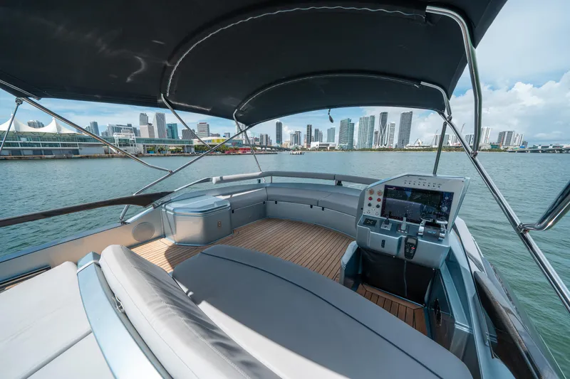 Slide: The Image of Luxurious 2017 Riva 76' Perseo yacht with city skyline view, spacious deck, and modern controls. - 16