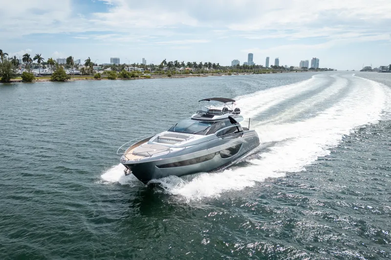 Slide: The Image of Riva 76' Perseo 2017 yacht cruising on open water, city skyline in background. - 3