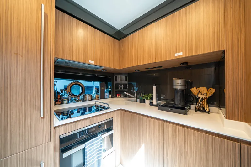 Slide: The Image of Modern kitchen interior on 2017 Riva 76' Perseo yacht with wood cabinetry and appliances. - 34