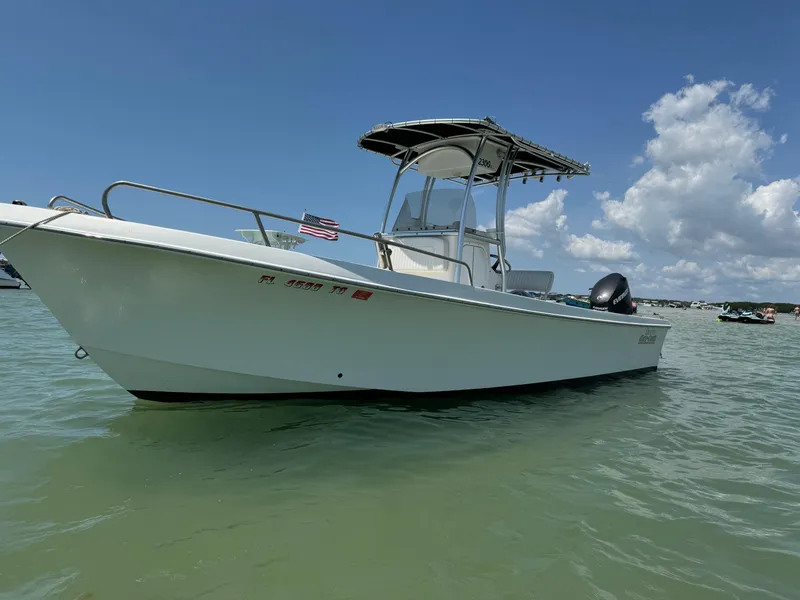 The Image of 2017 May-Craft 2300CCX boat on calm water under blue sky. - 0