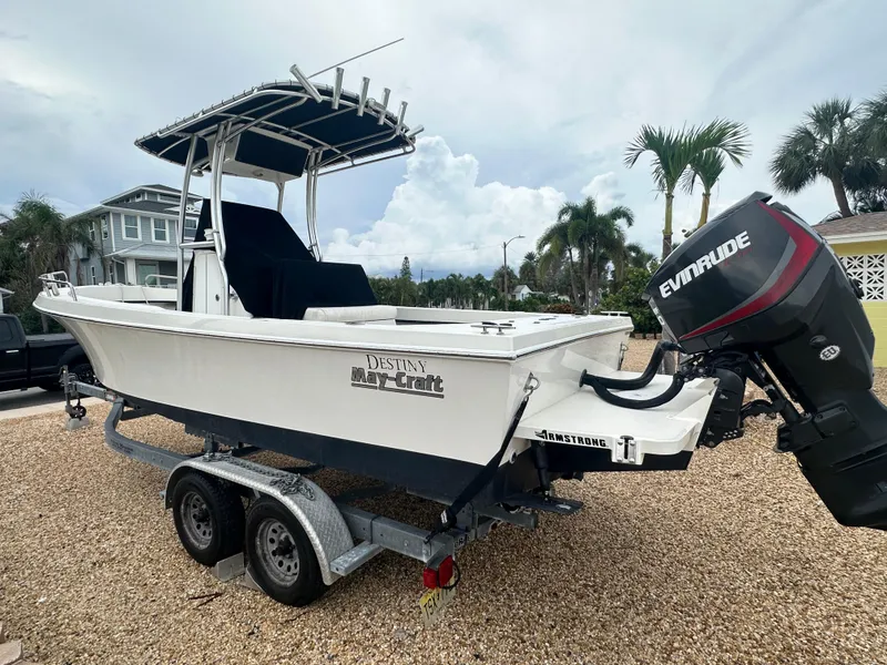 Slide: The Image of 2017 May-Craft 2300CCX boat on trailer with Evinrude motor, parked outdoors. - 10