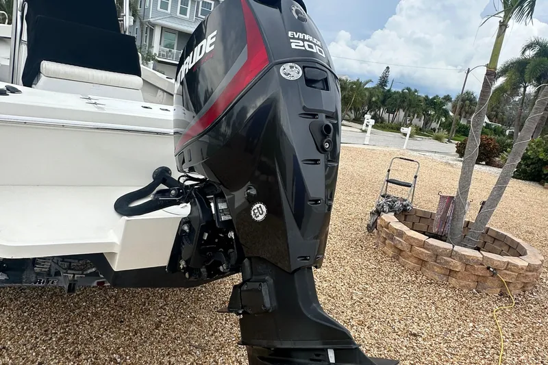 Slide: The Image of 2017 May-Craft 2300CCX with Evinrude 200 outboard motor in a coastal setting. - 15