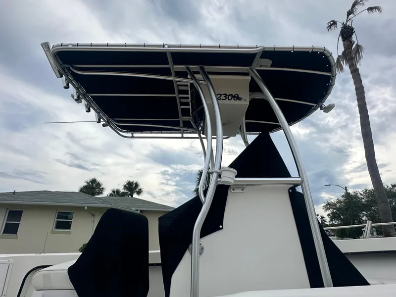 Slide: The Image of 2017 May-Craft 2300CCX boat with T-top against cloudy sky. - 17