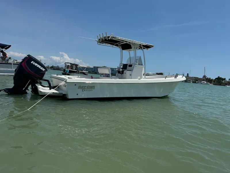 Slide: The Image of 2017 May-Craft 2300CCX boat on water with Evinrude motor. - 2