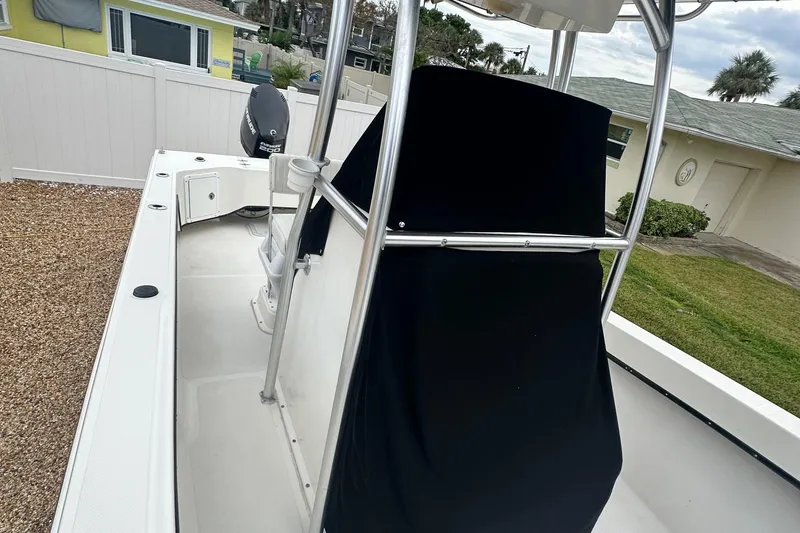Slide: The Image of 2017 May-Craft 2300CCX boat with covered console, parked outdoors. - 22
