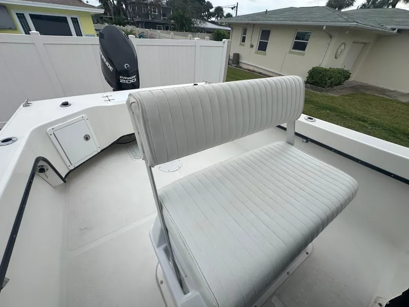 Slide: The Image of 2017 May-Craft 2300CCX boat interior with seating and outboard motor. - 28