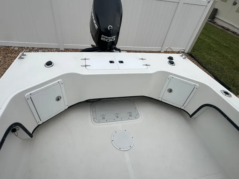 Slide: The Image of 2017 May-Craft 2300CCX boat interior with storage compartments and outboard motor. - 30