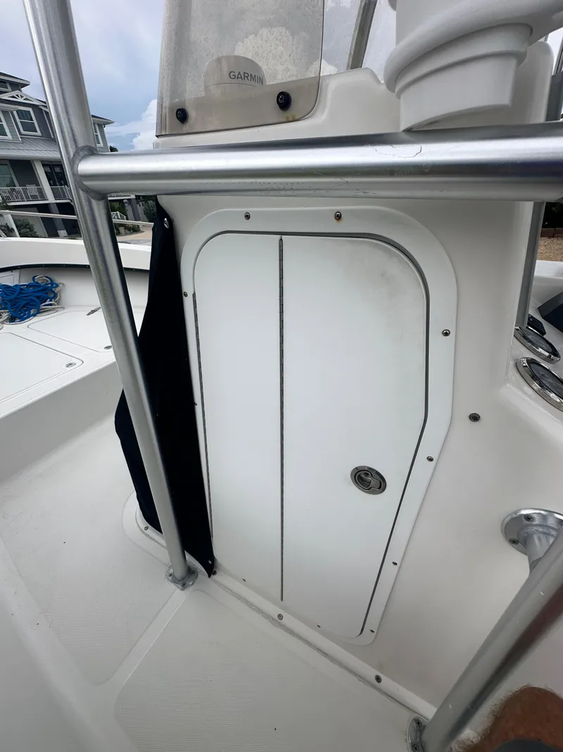 Slide: The Image of 2017 May-Craft 2300CCX boat console with storage compartment and railing. - 33