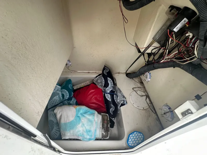 Slide: The Image of 2017 May-Craft 2300CCX storage compartment with towels and wiring. - 34