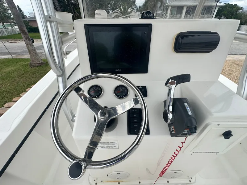 Slide: The Image of 2017 May-Craft 2300CCX boat console with steering wheel and controls. - 37